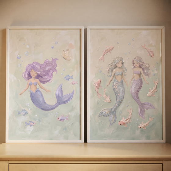 Dreamy sea mermaid wall art set of 2 featuring pastel mermaids and small fish in a soft green underwater environment.