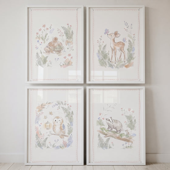 Dreamy watercolor forest animal wall art set of 4 featuring a turtle, deer, owl, and badger in white frames.
