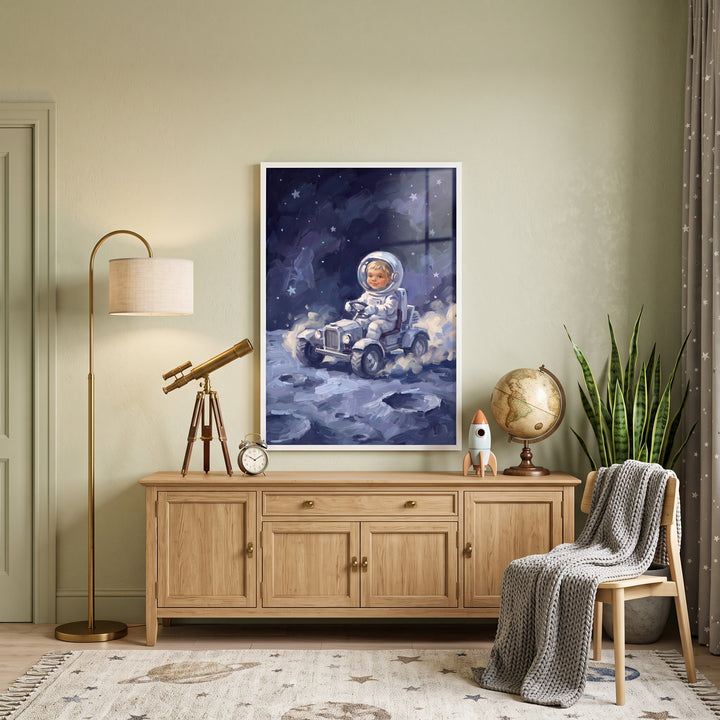 Driving moon rover astronaut wall art hangs above a wooden cabinet in a room with a telescope, globe, and a chair.