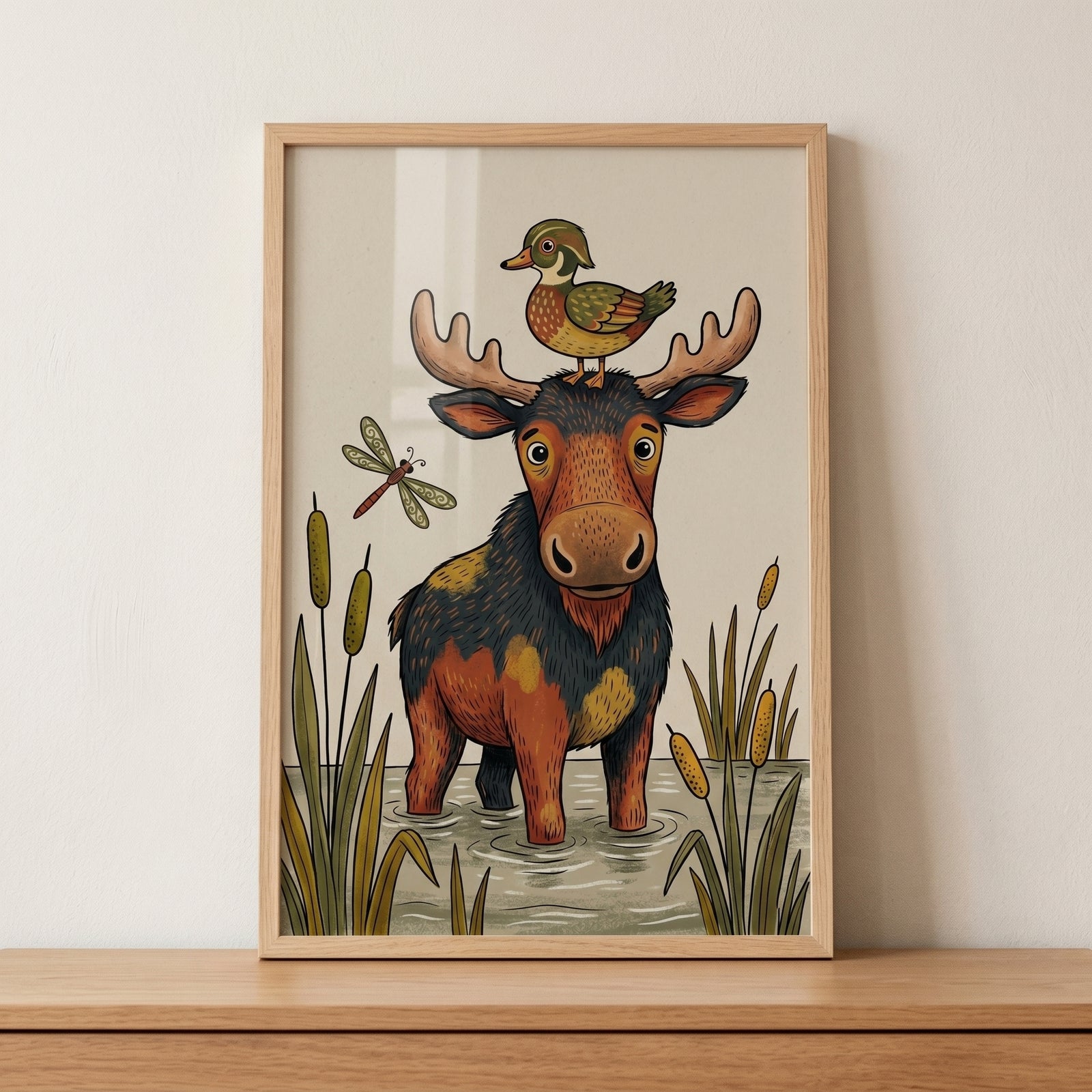 Framed duck on head moose animals wall art depicts a friendly moose and wood duck in a pond with cattails.