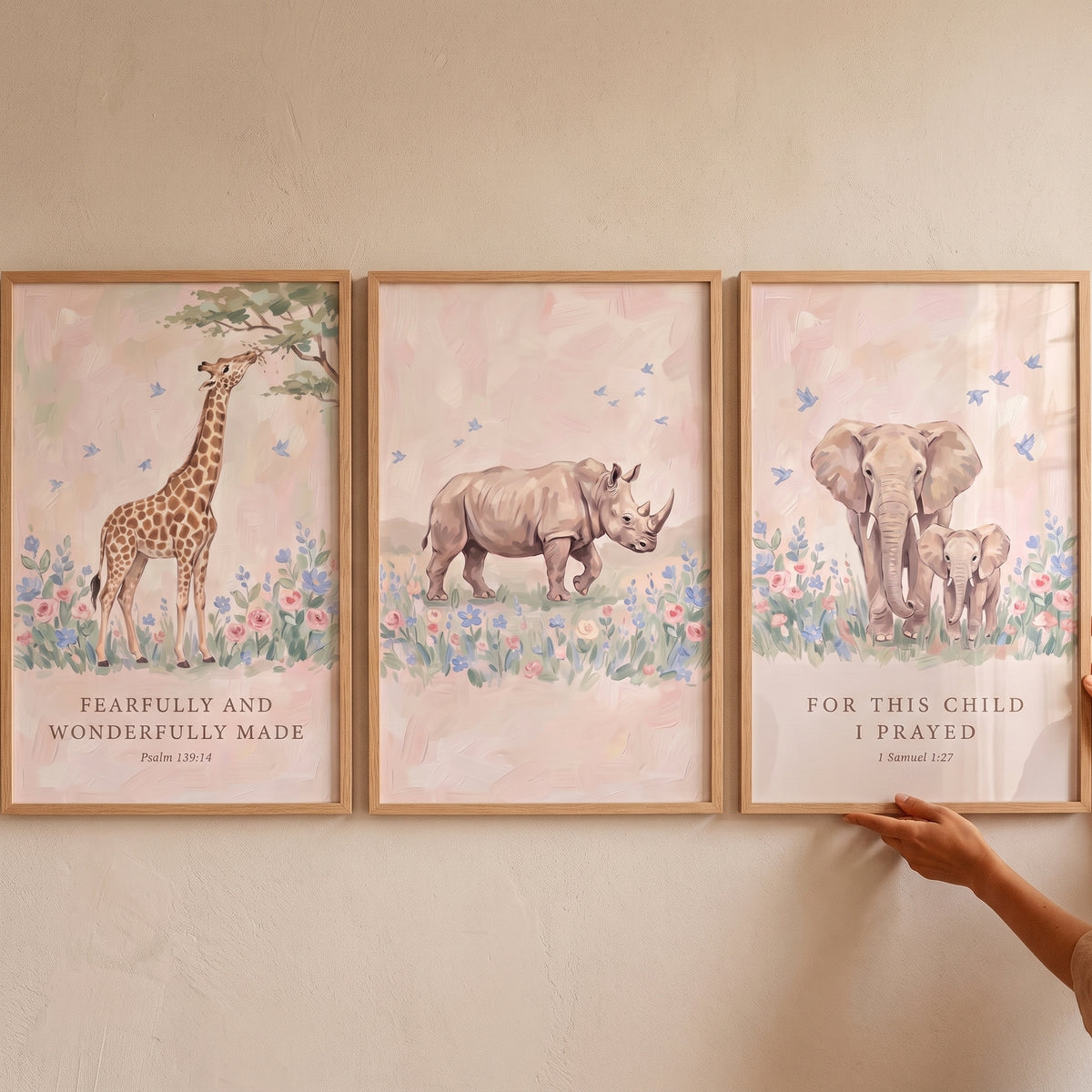Dusty pink safari animals wall art set of 3 with a giraffe, rhino, and elephants featuring scripture in wood frames.