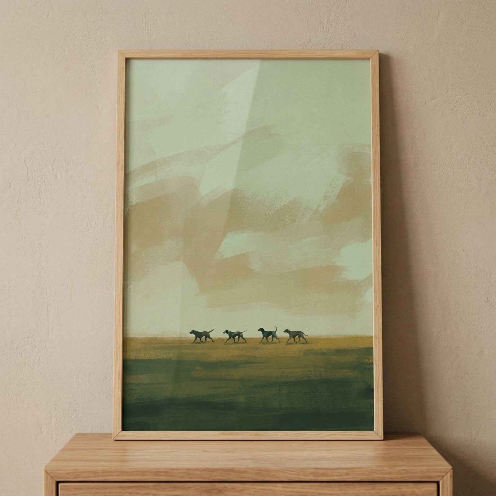 A vertical minimalist illustration of four slender canine silhouettes walking in a line across a level horizon. The composition features a dark moss-green horizontal band in the foreground. Above the dogs, the background is an abstract arrangement of large, textured sweeps of sage green and warm beige, creating a sense of a distant landscape. The style is modern and serene, characterized by broad, visible strokes and a muted earth-tone color palette. 