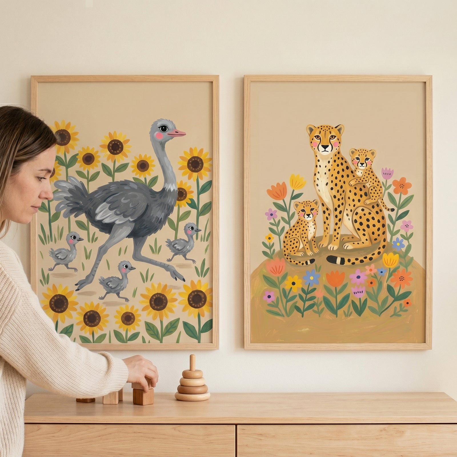 Earthy botanical savanna animal print set of 2 featuring ostrich and cheetah families hung on a wall above wooden toys.