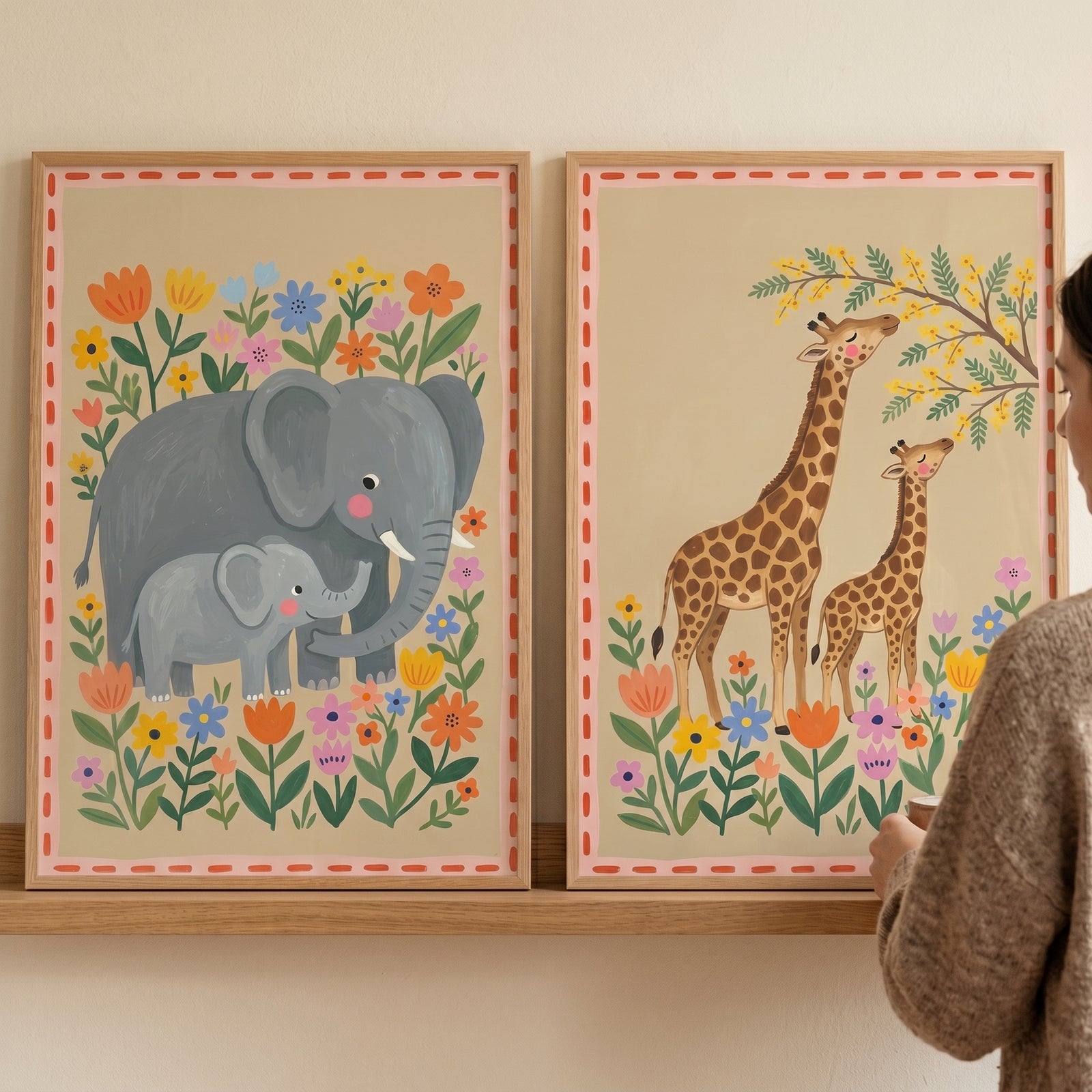 Earthy mama baby savanna animal artwork set of 2 displays framed elephant and giraffe pairs with colorful flowers.