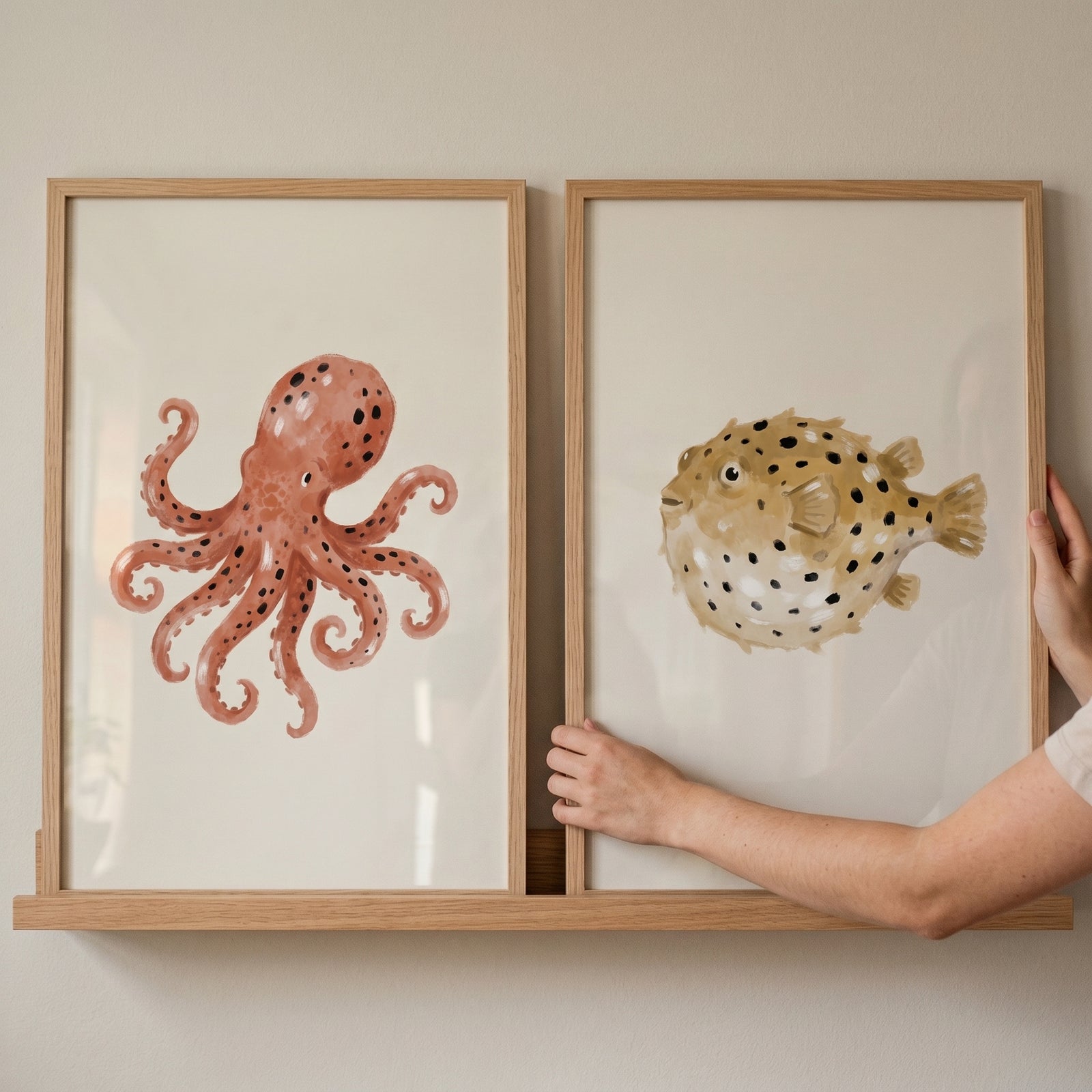 Earthy neutral sea creature wall art set of 2 featuring an octopus and pufferfish in wooden frames.