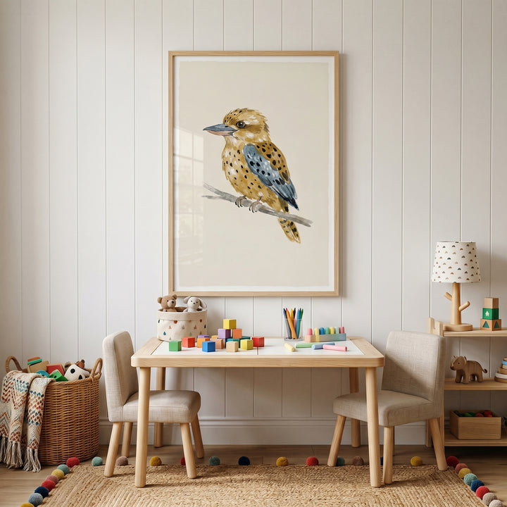 Earthy spotted kookaburra bird wall art hangs in a neutral playroom above a wooden table set with colorful blocks.