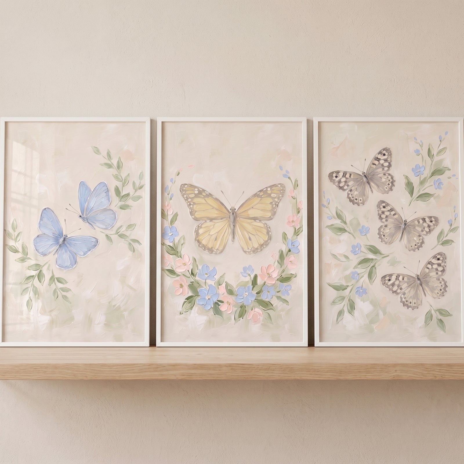 Earthy tone botanical butterfly wall art set of 3 featuring blue, yellow, and grey butterflies with soft floral accents.