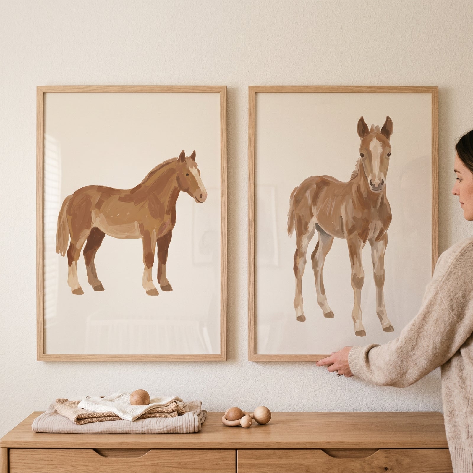 Earthy tone brown horse wall art set of 2 depicting a horse and foal above a wooden dresser with nursery items.