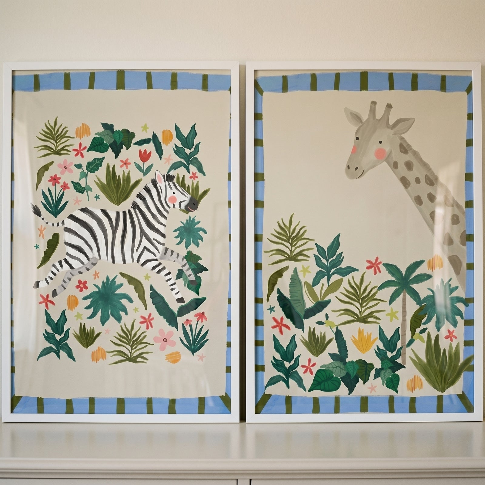 Earthy tone safari animal wall art set of 2 featuring a zebra and a giraffe among lush jungle foliage and flowers.