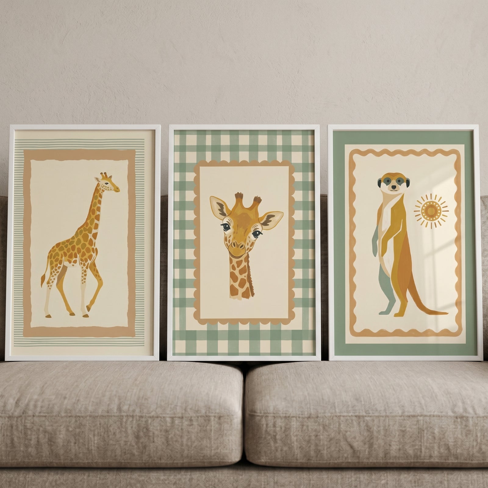 Framed earthy tone savanna animal wall art set of 3 with illustrations of giraffes and a meerkat above a beige sofa.