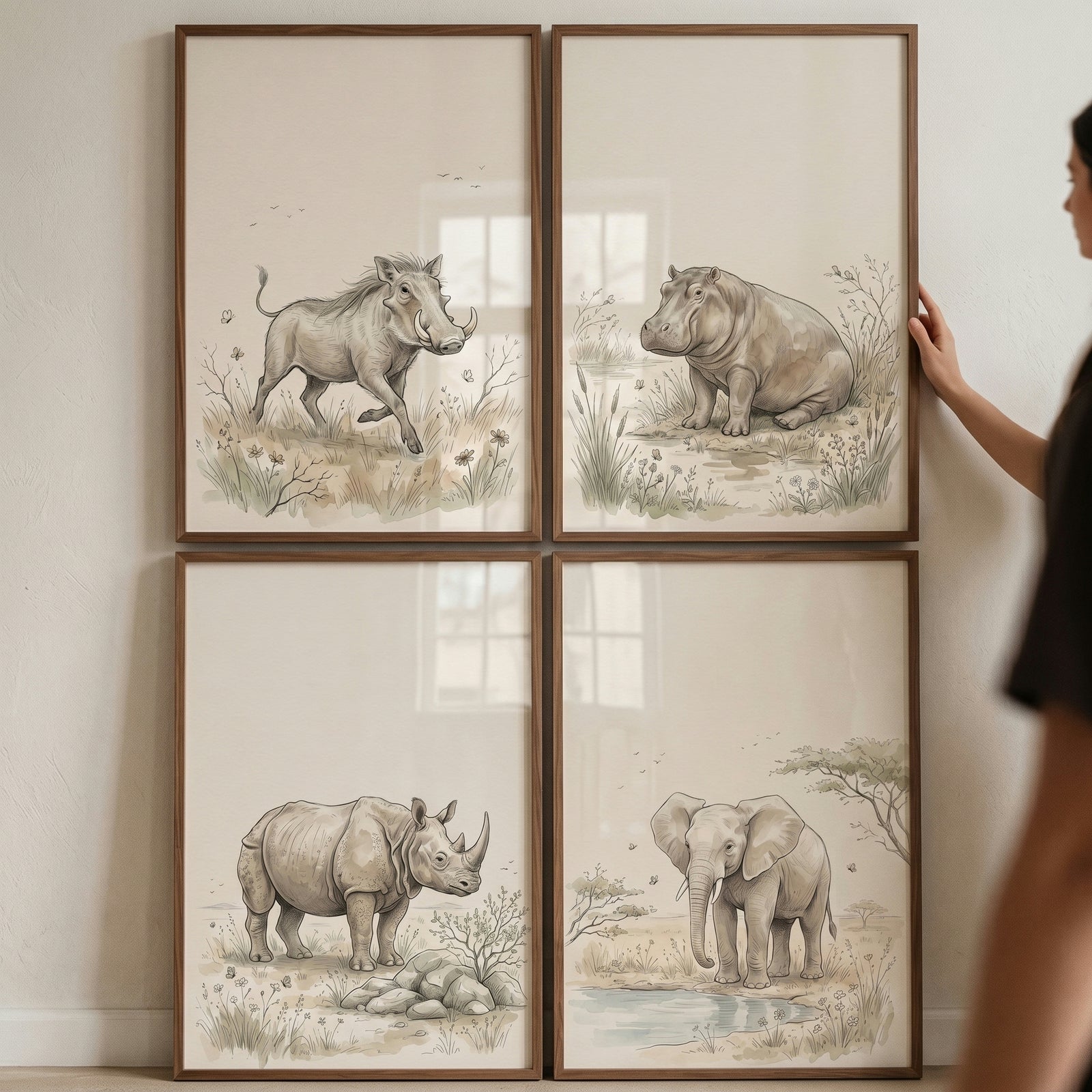 Earthy tone savanna animals wall art set of 4 includes framed illustrations of a warthog, hippo, rhino, and elephant.