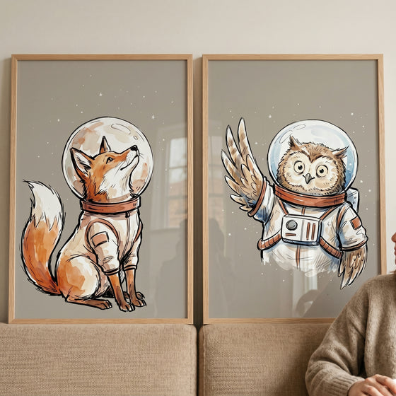 Earthy watercolor astronaut animal wall art set of 2 featuring a fox and an owl in space suits with glass helmets.
