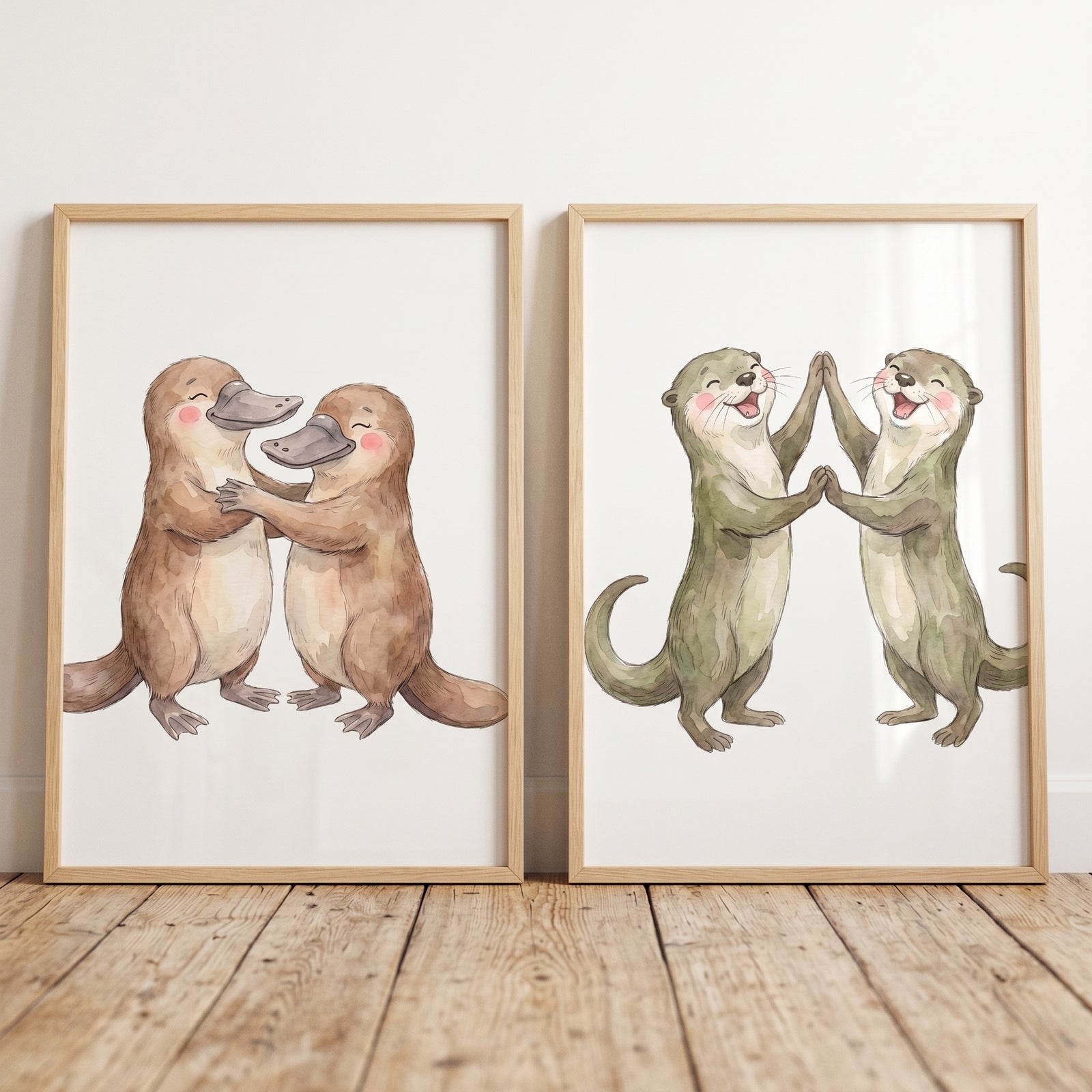 Cute platypuses and otters in an earthy watercolor dancing animals wall art set of 2, displayed in wooden frames.