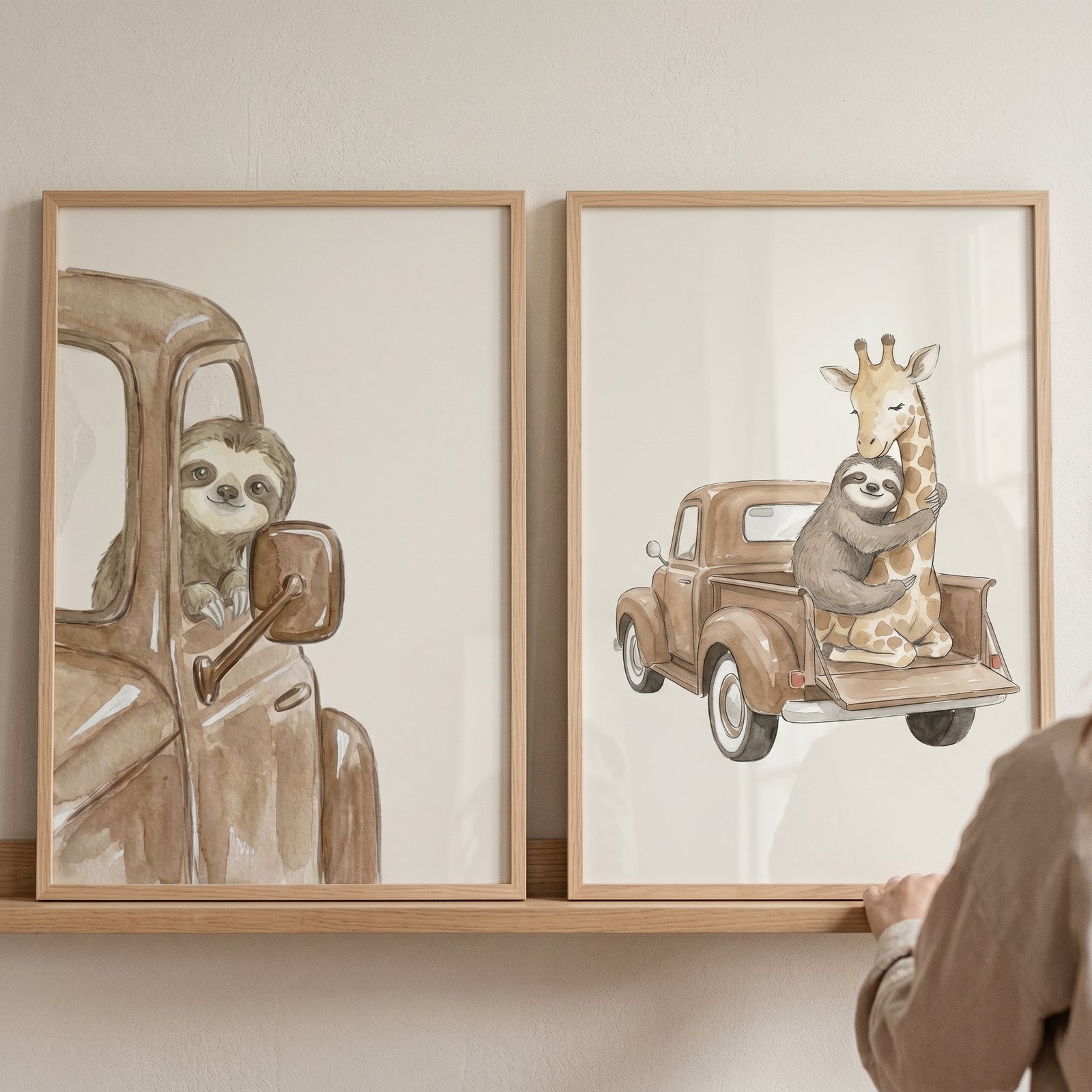 Earthy watercolor truck animals wall art set of 2 with a sloth driving a truck and one hugging a giraffe in a truck bed.