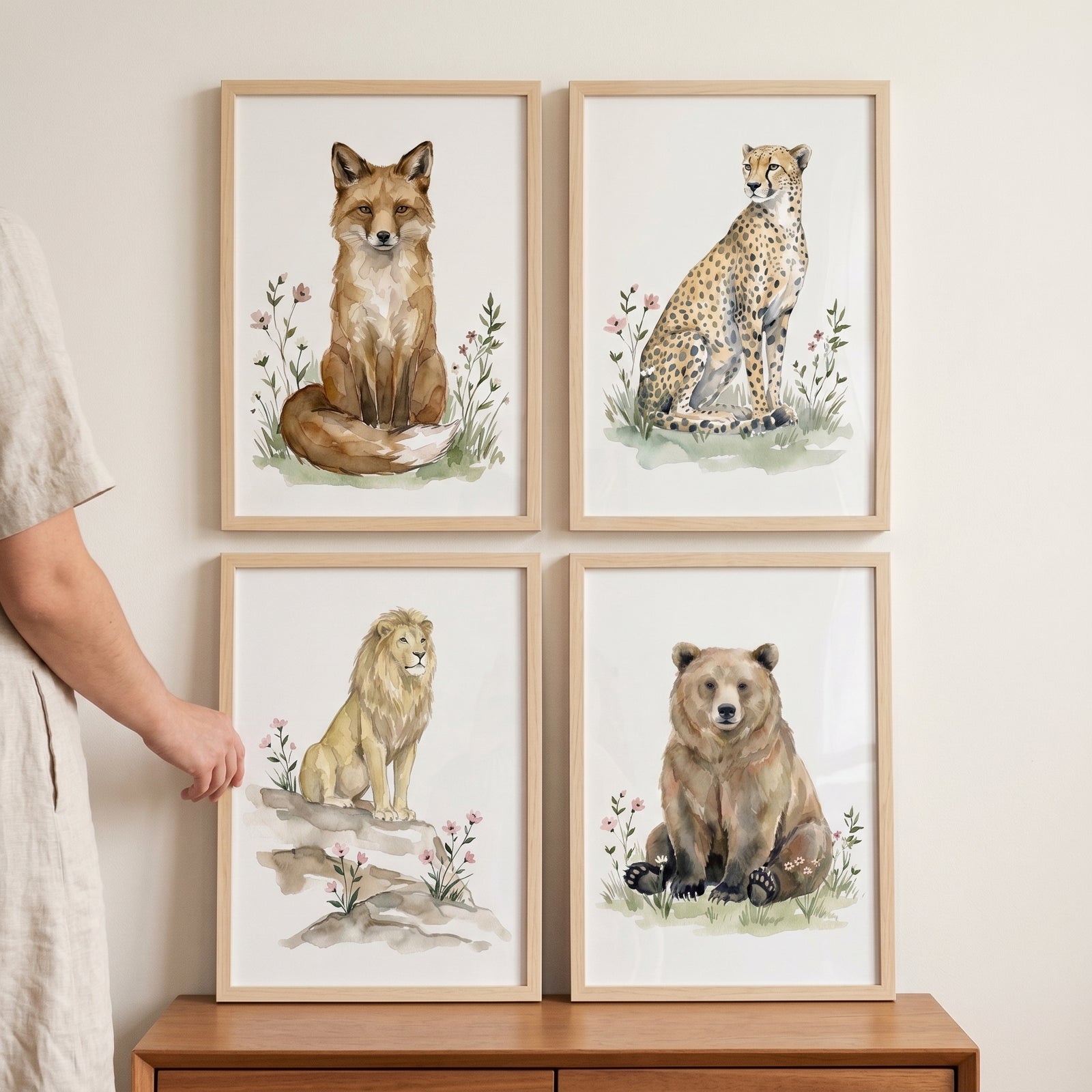 Earthy wildlife animal wall art set of 4 featuring a watercolor fox, cheetah, lion, and bear in light wood frames.