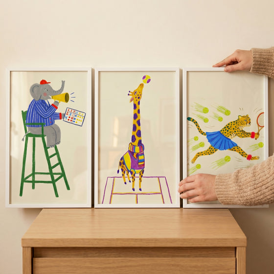 Eclectic dressed tennis animal wall art set of 3 featuring a colorful elephant, giraffe, and cheetah in sports gear.
