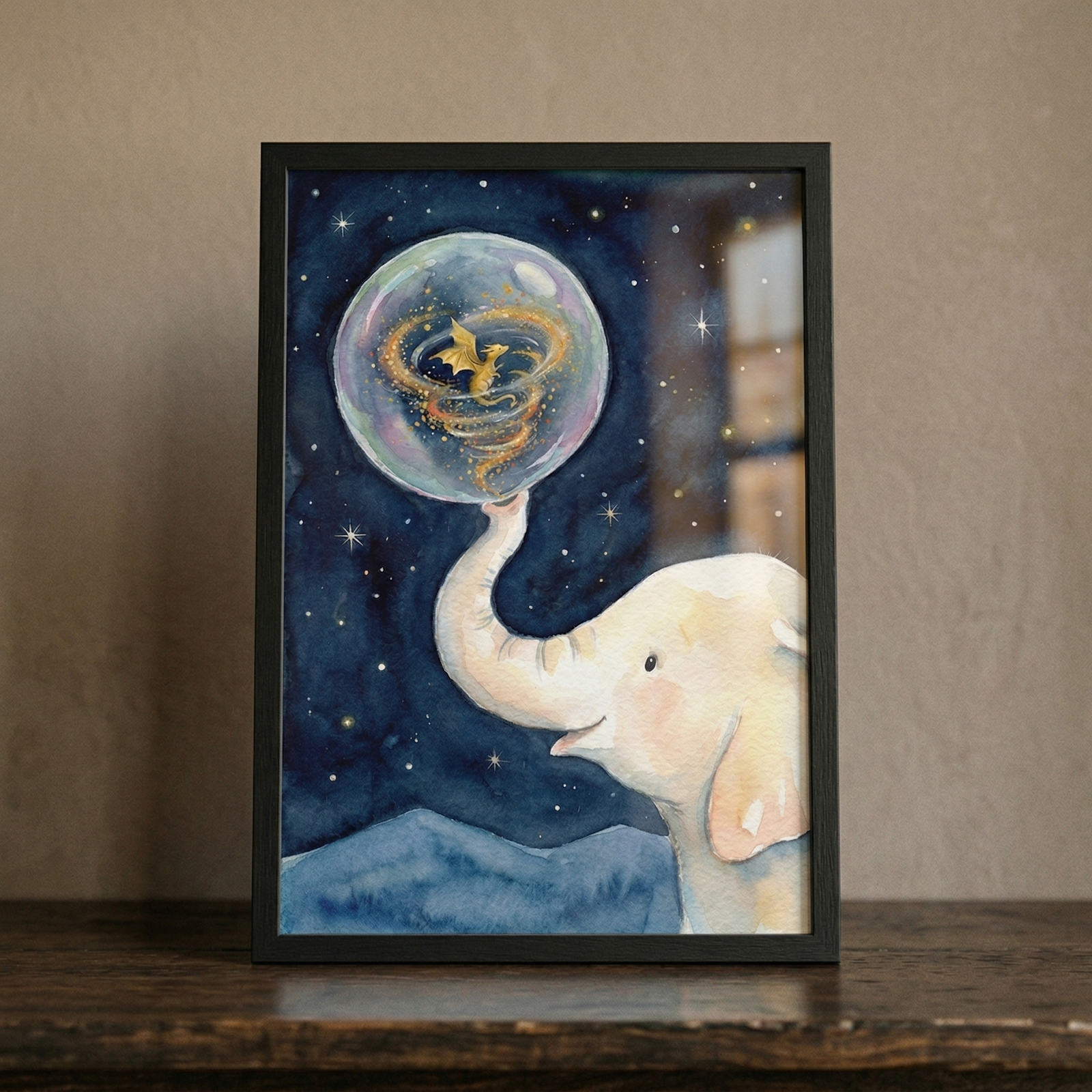 A vertical framed watercolor-style illustration of a gentle white baby elephant with its trunk raised toward a deep indigo starry night sky. The elephant is balancing a large, shimmering iridescent bubble on the tip of its trunk. Inside the bubble, a tiny golden winged creature is surrounded by a swirl of golden light. The baby elephant has a soft expression with a small smile and delicate pink tones on its ears and cheeks. Below the elephant are dark blue mountainous shapes. 