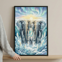 A vertical watercolor-style illustration depicts an elephant family, consisting of two large adults and a small calf centered between them. They stand in a landscape of snow and ice, surrounded by large, translucent blue and white crystals. Above them, a glowing yellow sun is set against a sky filled with vibrant, swirling patterns of teal, purple, and green light. The elephants’ grey skin features delicate frost and snowflake patterns.