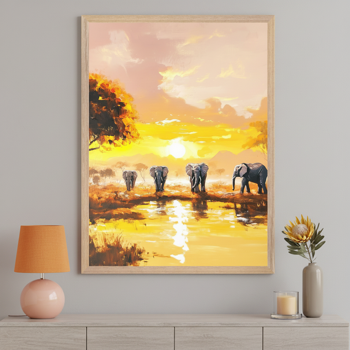 Modern room with a light wood dresser. A large framed oil painting depicting elephants walking by a water source in a savanna at a bright orange sunset hangs centered above the dresser.
