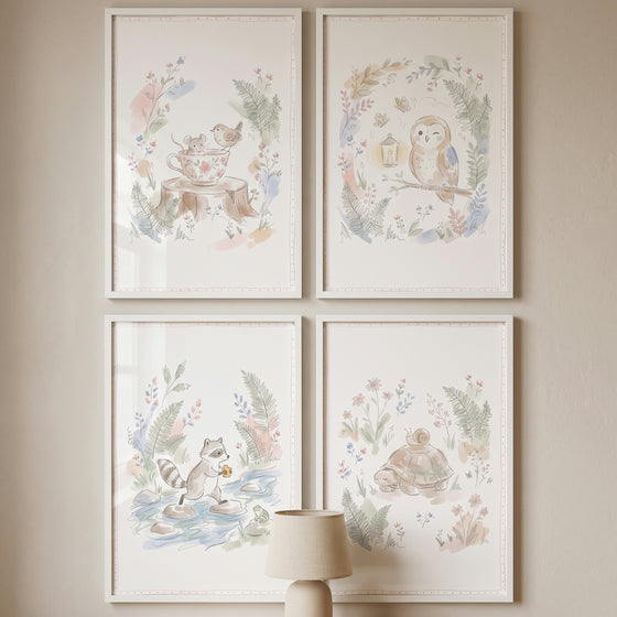 Enchanted nature forest animal wall art set of 4 watercolor illustrations of woodland creatures in white frames on a wall.