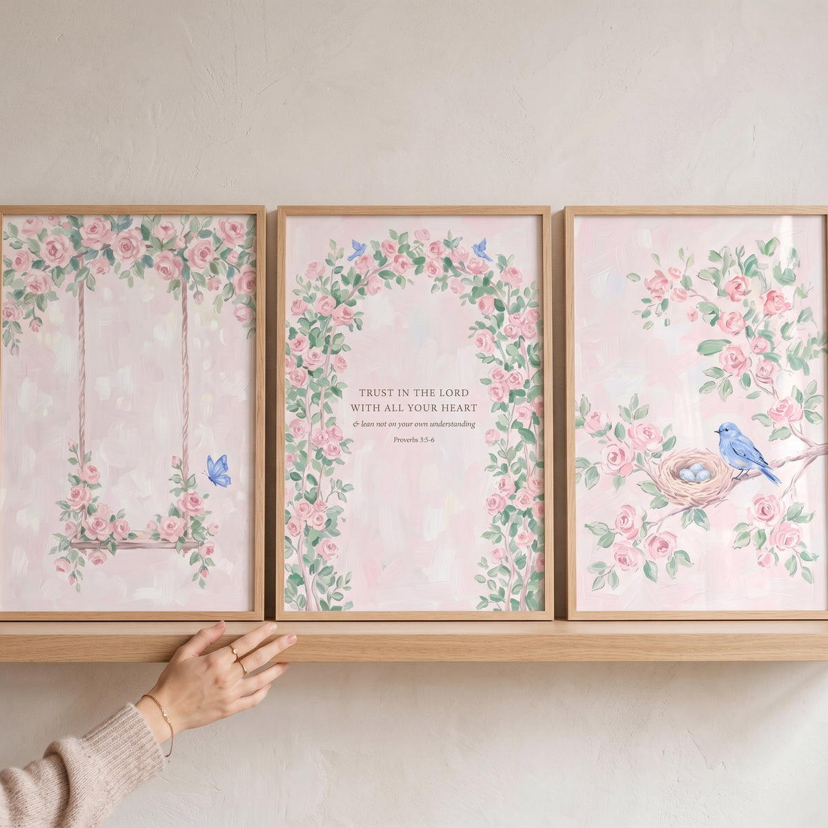 english floral pink rose wall art set of 3 featuring a swing, a floral arch with scripture, and a blue bird on a shelf.