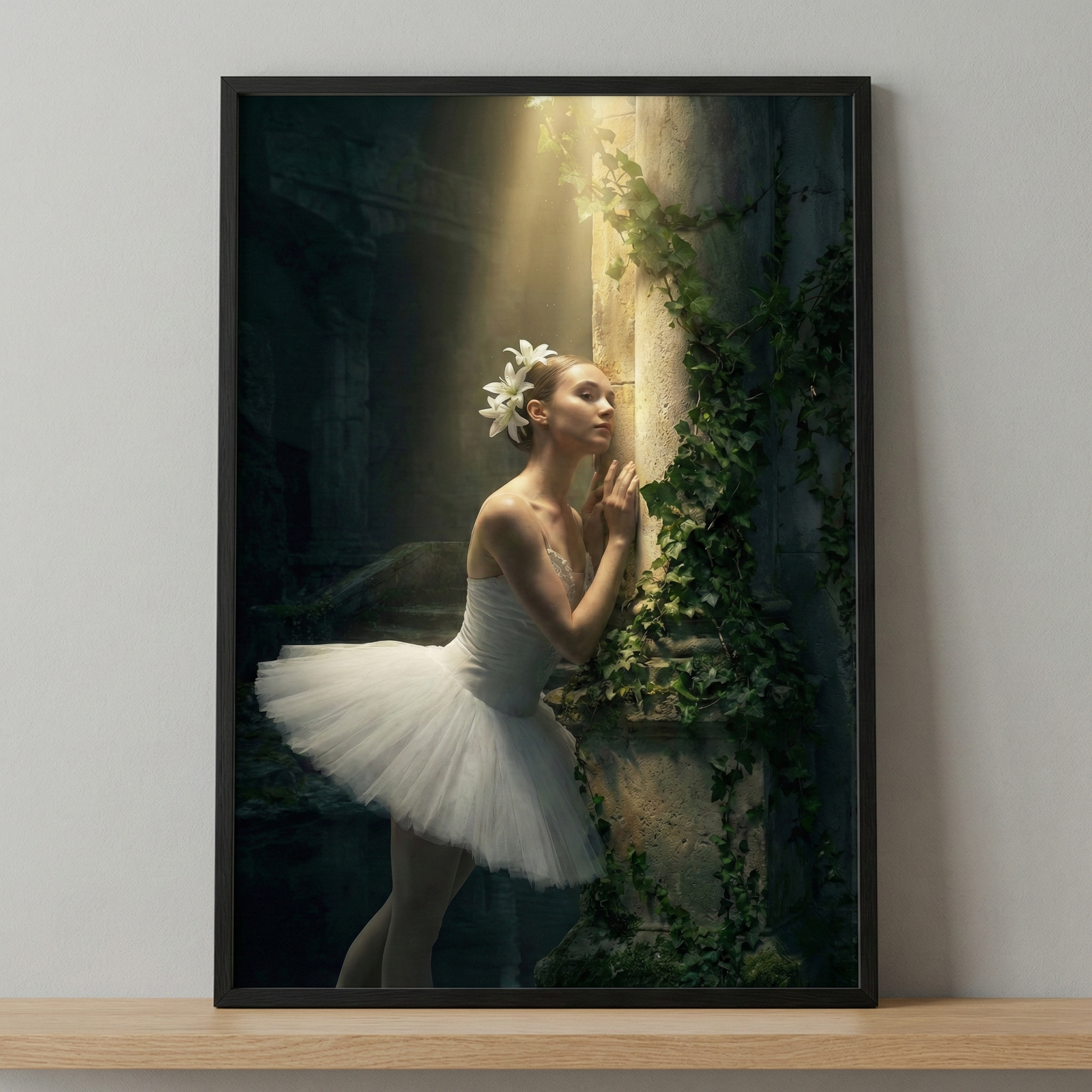 A framed vertical image depicting a ballerina in a white tutu leaning against a mossy stone pillar. She has white flowers in her hair and an expression of quiet contemplation. A dramatic shaft of golden sunlight falls from above, highlighting her figure and the ivy on the stone. The surrounding environment is dark and appears to be ancient ruins, creating a moody and ethereal atmosphere.