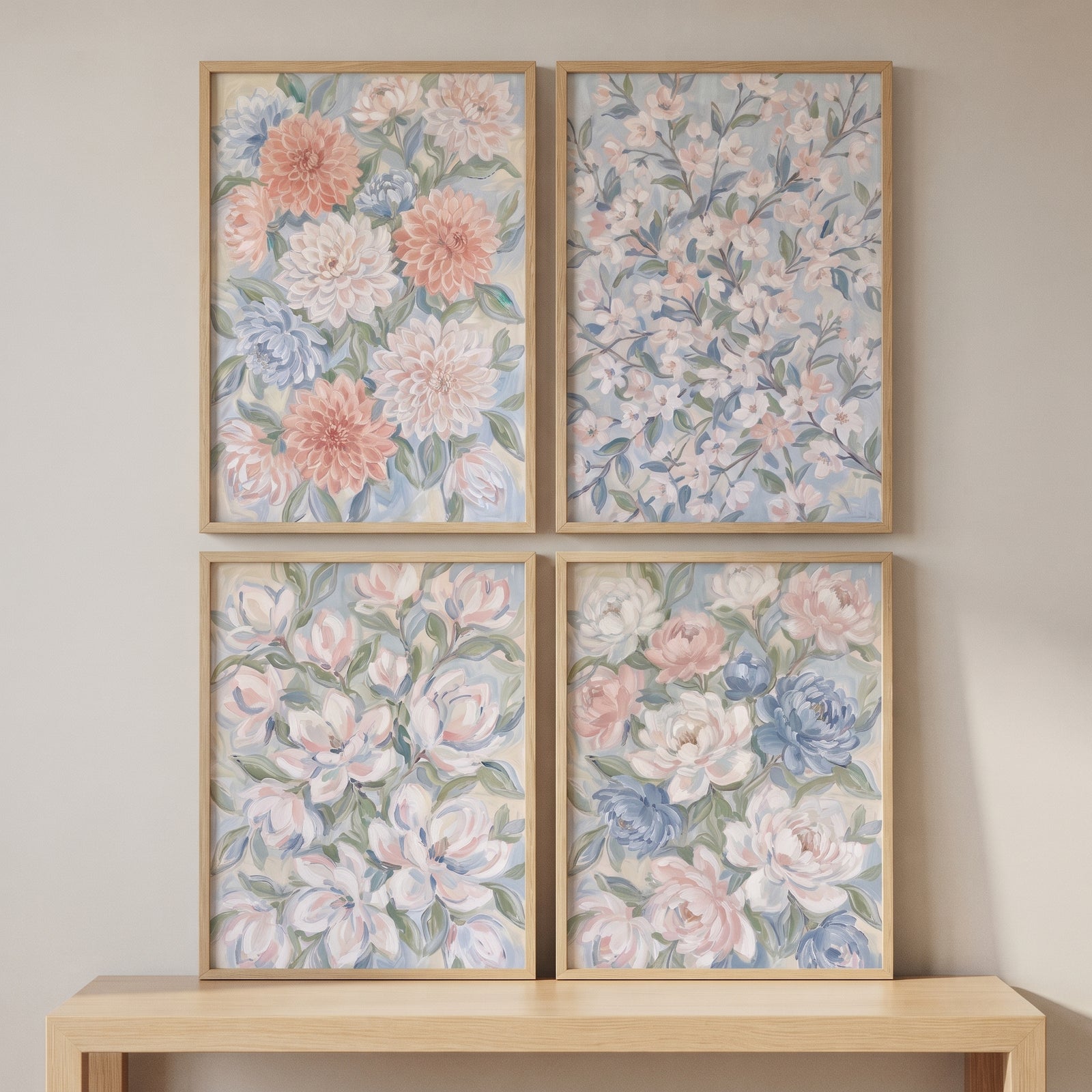 Ethereal blush botanical floral wall art set of 4 in wood frames hung on a neutral wall above a light wood table.