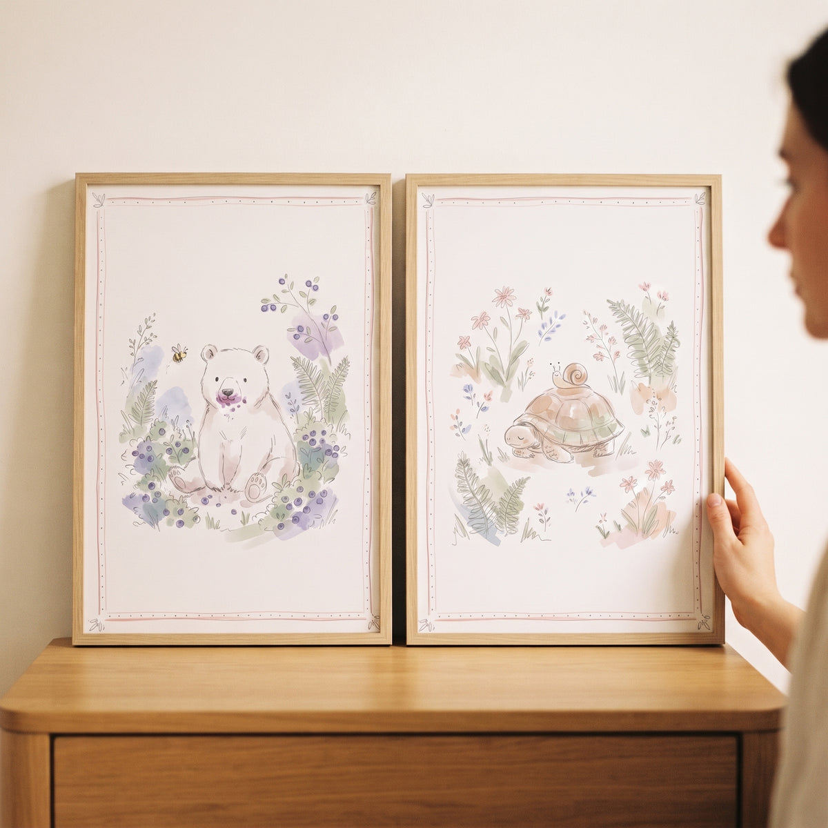 Ethereal botanical woodland animal wall art set of 2 featuring a bear and turtle in wood frames on a dresser.