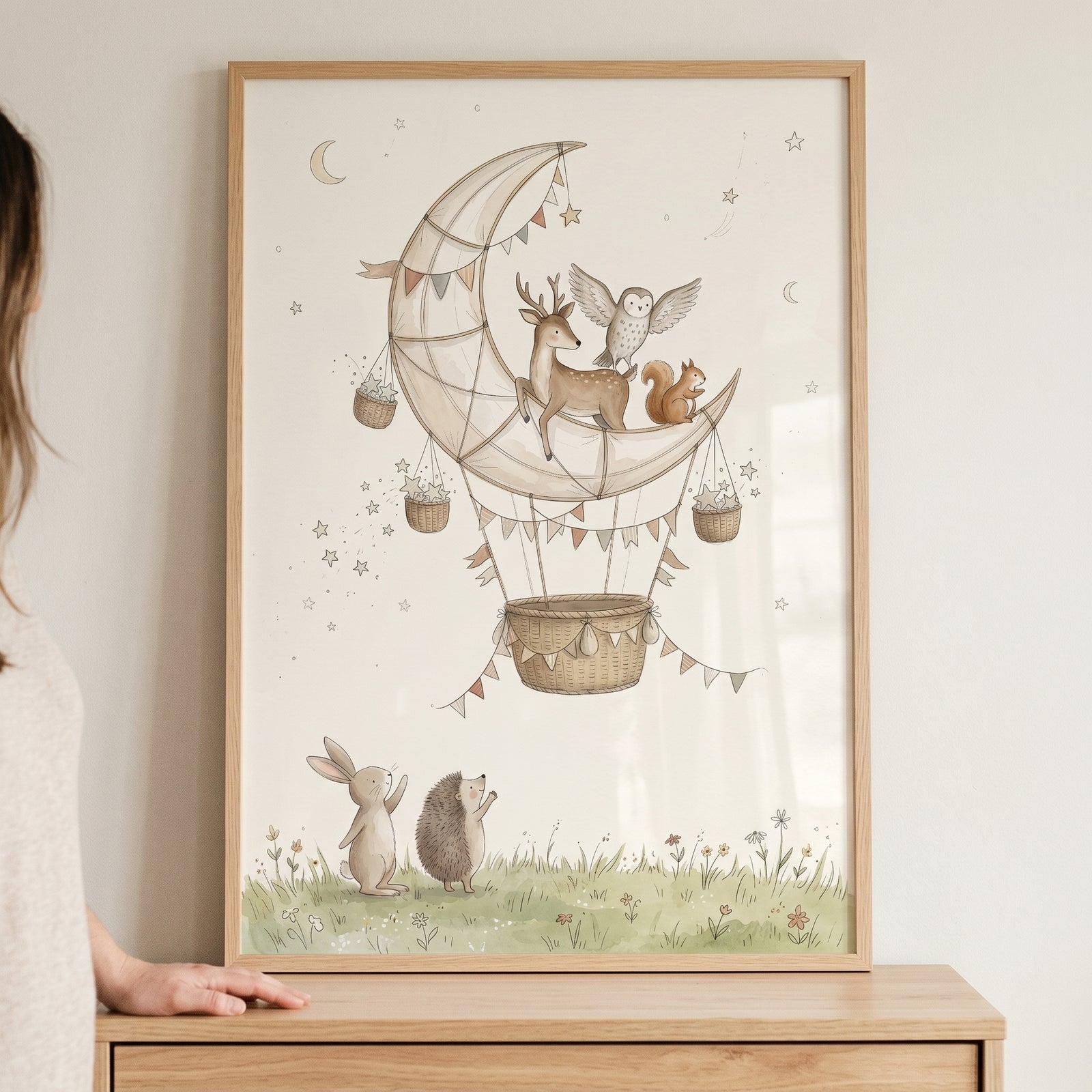 Ethereal moon balloon animals wall art depicts a deer, owl, and squirrel on a crescent moon above a rabbit and hedgehog.