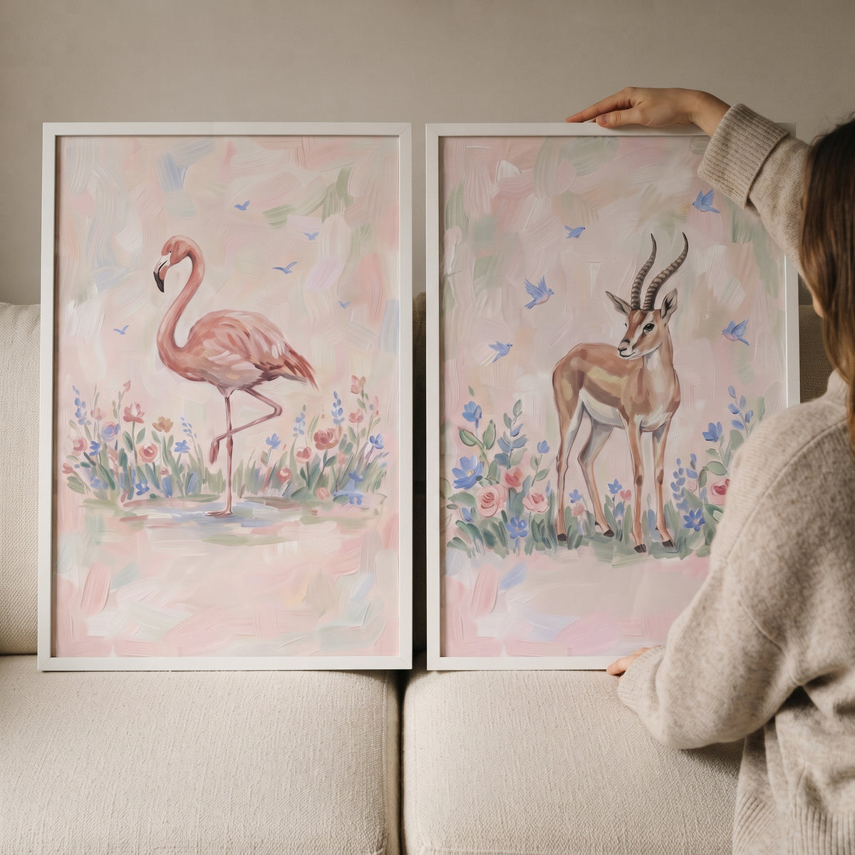 Ethereal pastel safari animals wall art set of 2 featuring a flamingo and gazelle against a soft floral background.