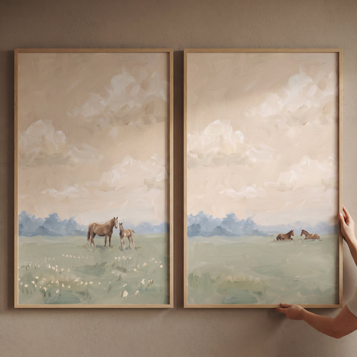 Ethereal peach sky horses wall art set of 2 depicts horses in a meadow under a soft, cloudy peach sky and blue trees.