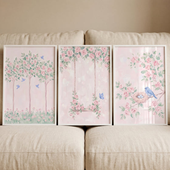 Ethereal pink rose garden wall art set of 3 depicts trees, blue birds, a floral swing, and a nest in soft pastel colors.