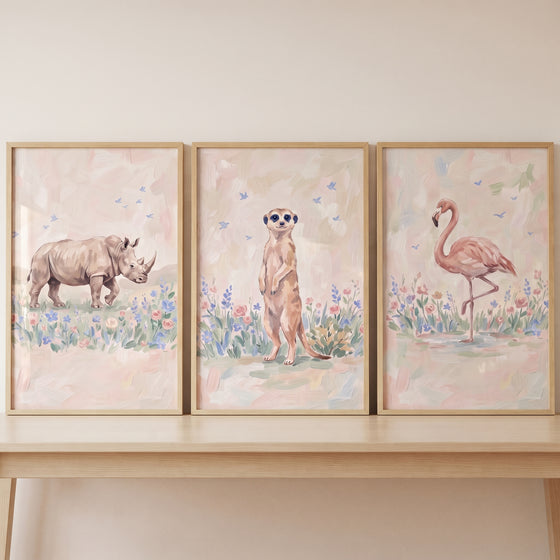Ethereal wildflower savanna animals wall art set of 3 with a rhino, meerkat, and flamingo in soft floral settings.