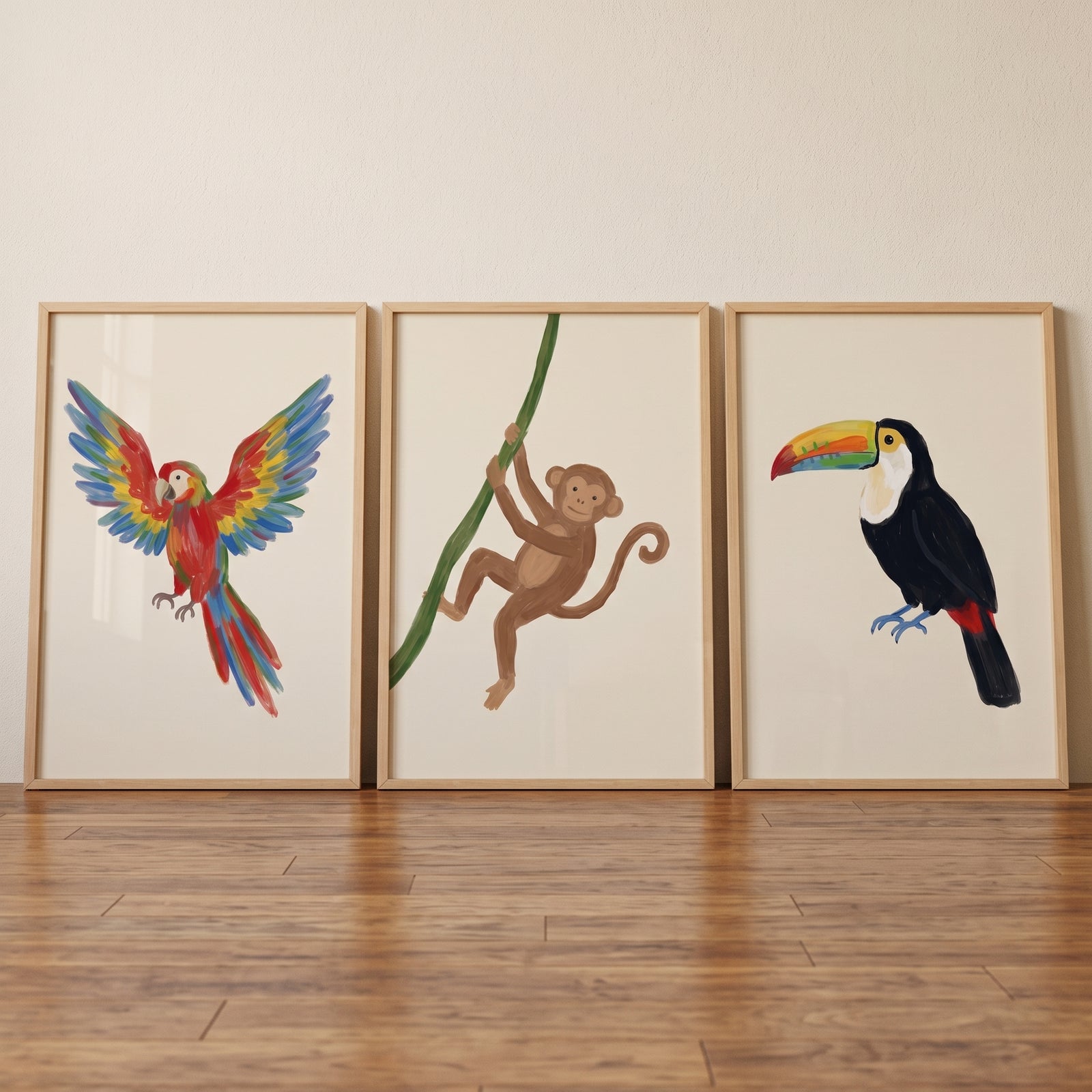 Exotic tropical jungle animal wall art set of 3 featuring a colorful parrot, a monkey, and a toucan in light wood frames.