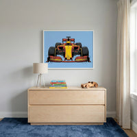 A vibrant Formula 1 car artwork, featuring a head-on view of a red and yellow race car, adds energy to a child’s room. The bold design and bright colors create a sporty contrast with soft neutrals and playful wooden toys.