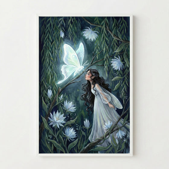 A framed vertical illustration of a young woman with long, dark, wavy hair and pointed ears, wearing a flowing, translucent white gown. She is looking up with an expression of wonder at a large, luminous, white butterfly resting on a tree branch. The scene is set in a dark, magical forest at night, surrounded by lush green willow leaves and several large, glowing, star-shaped white flowers. The light from the butterfly and flowers softly illuminates the scene, creating a whimsical and ethereal atmosphere.