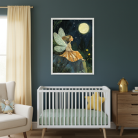Modern nursery with a white crib, light green sheet, and yellow star pillow against a dark teal wall. A large framed illustration of a fairy sitting on a rock looking at a full moon in a forest hangs centered above the crib. A beige armchair and wooden dresser are also visible.