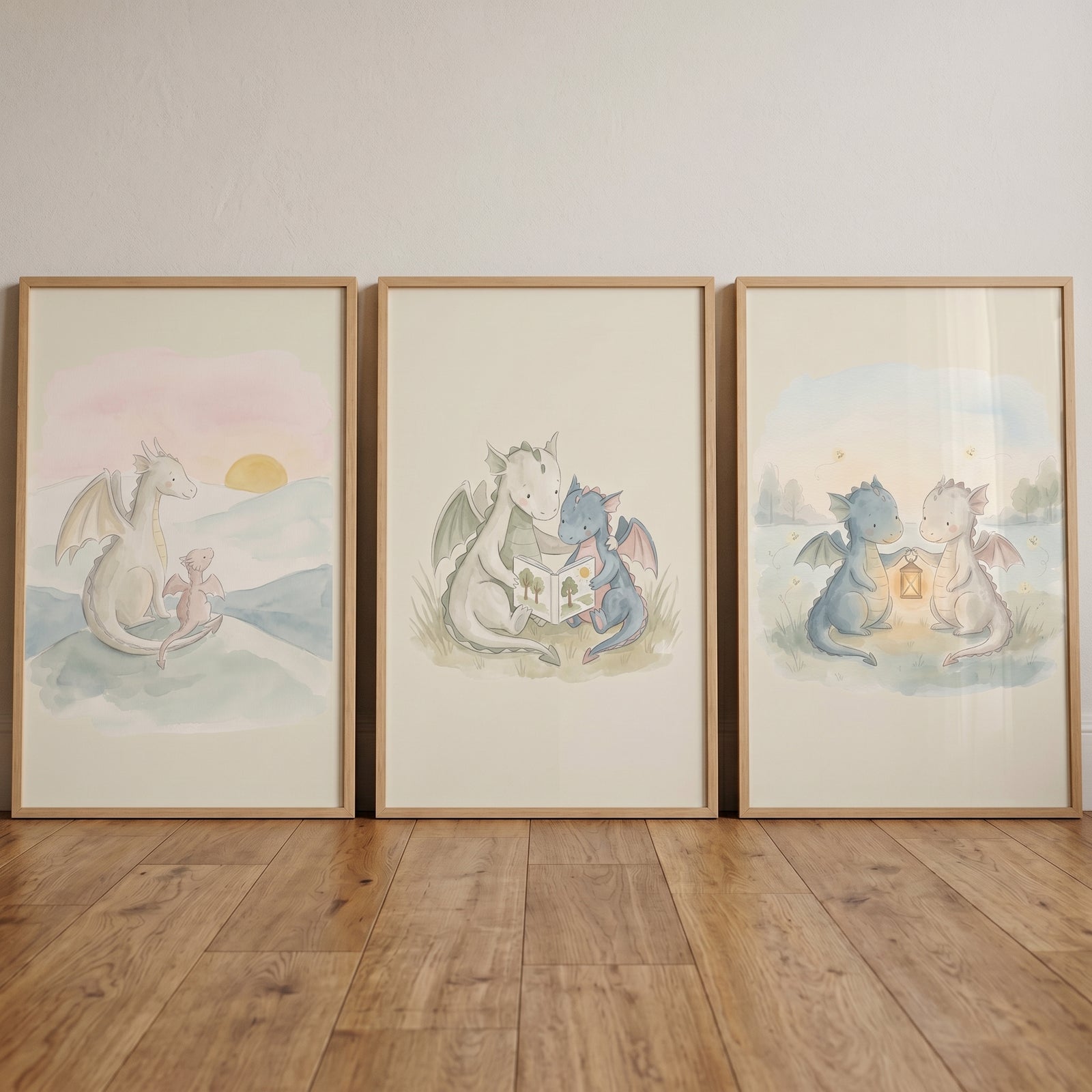 Fairytale storybook baby dragons wall art set of 3 showing watercolor dragons reading, holding a lantern, and at sunset.