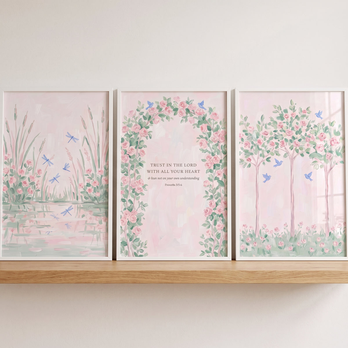Fairytale watercolor pink garden wall art set of 3 featuring a pond, a scripture floral arch, and flowering trees.