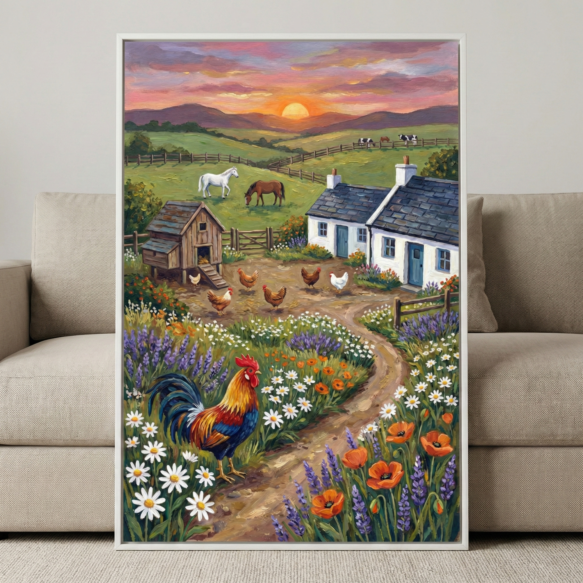 A vibrant rooster with multi-colored plumage stands in the foreground of a rural landscape artwork. The scene features a cozy farm with white cottages, blue doors, and a wooden chicken coop. A dirt path is lined with white daisies, orange poppies, and purple lavender. Brown and white chickens roam a yard, while horses and cows graze in green, fenced pastures. Rolling hills lead to distant mountains under a warm sunset sky of orange, pink, and purple. The framed art hangs above a sofa.
