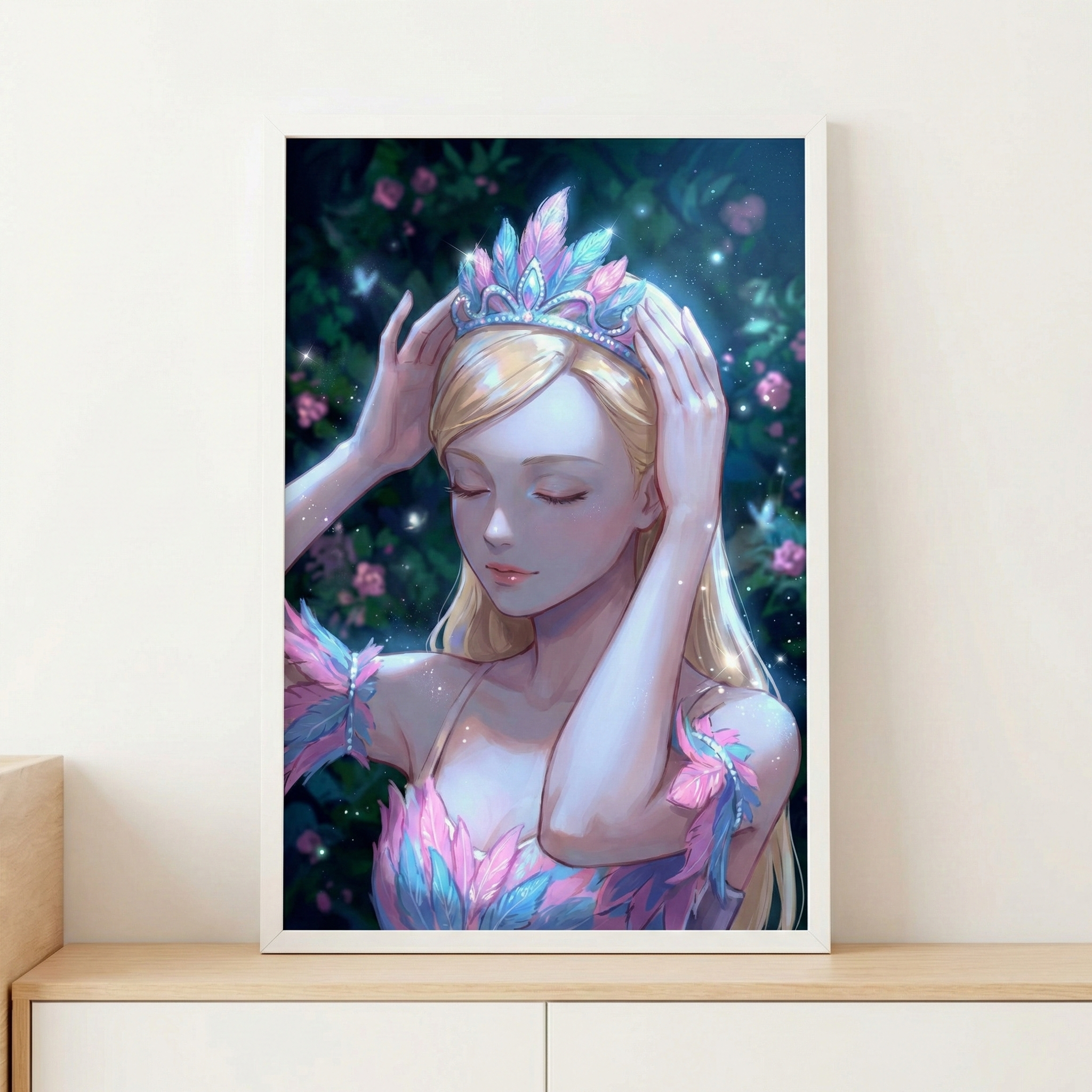 A framed digital artwork of a fair-haired young woman with her eyes closed, placing a luminous crown of pink and blue feathers on her head. Her attire is similarly feathered, shimmering in soft light. She stands in an enchanted forest at night, dotted with small pink flowers and glowing orbs. The framed piece rests on a wooden shelf against a white wall, conveying a dreamlike, fantasy-inspired scene.
