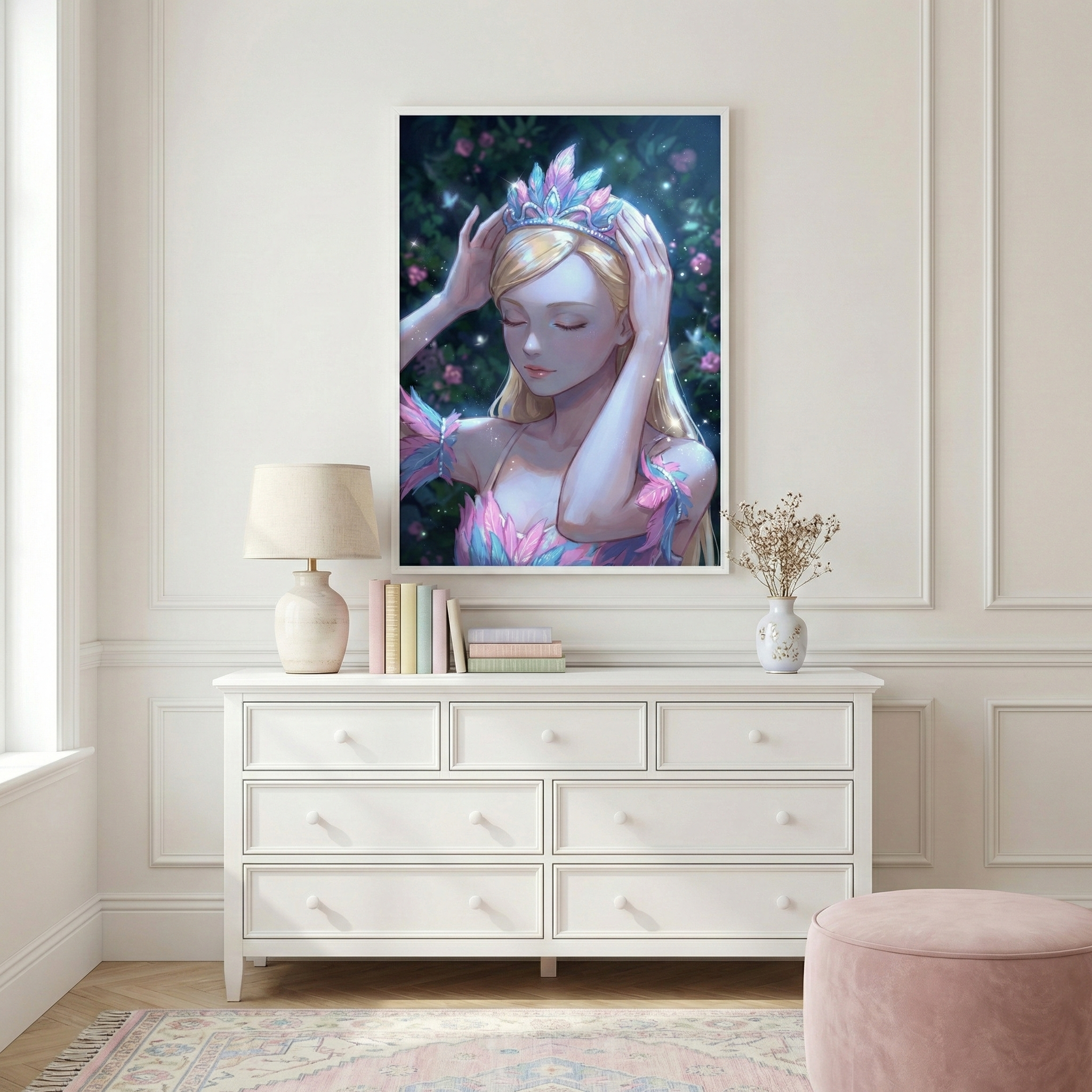 A bright room with white paneled walls features a large framed print above a white dresser. The artwork shows a serene girl with blonde hair and closed eyes, wearing a shimmering crown of pink and blue feathers. Beneath it, the dresser holds a lamp with a beige shade, a stack of pastel books, and a vase of dried flowers. To the right is a plush pink ottoman, and an intricate rug in soft tones covers the floor. Natural light streams from a side window.