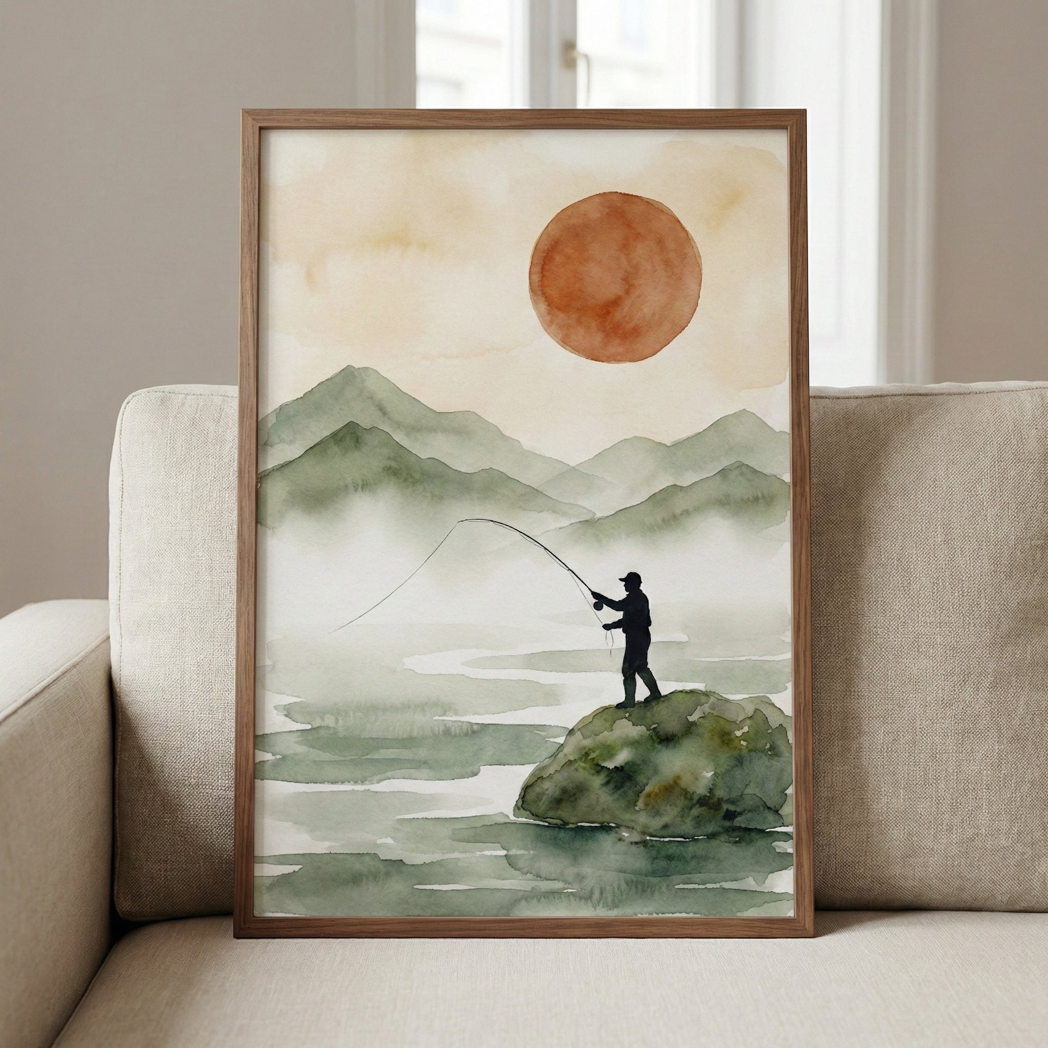 Watercolor painting of a lone fisherman casting his line from a mossy rock, with soft green mountains and a large rust-colored sun in the hazy background. The scene evokes calm and quiet solitude in nature.