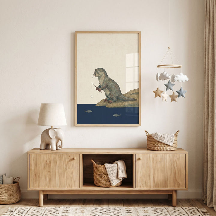 Fishing rod brown otter wall art hangs above a wooden cabinet with an elephant lamp and a star and cloud mobile.