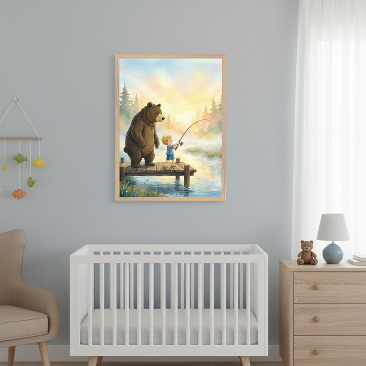 Modern nursery with a white crib, wooden dresser, and armchair. A framed watercolor-style print of a bear and a boy fishing on a dock at sunrise hangs on the gray wall above the crib.