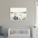 Nursery with a white crib, blue armchair, and white dresser. A framed painting of a child fishing with a golden retriever by a lake hangs centered above the crib.
