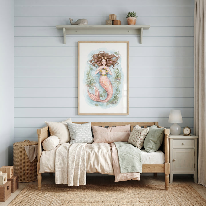 Floral crown mermaid wall art hangs above a wooden daybed in a light blue shiplap room with a jute rug and nightstand.