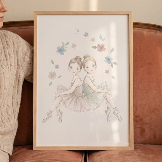 Framed floral wreath watercolor ballerina wall art featuring two girls in tutus sitting back-to-back.