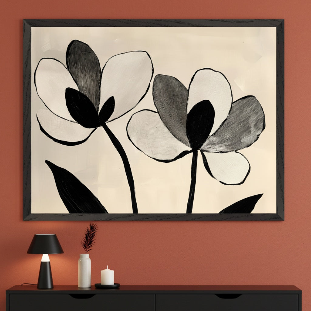 Modern room with a rust-colored wall and black dresser. A large black-framed painting of two abstract black, white, and gray flowers hangs centered above the dresser. A black lamp, white vase with a feather, and white candle are on the dresser.
