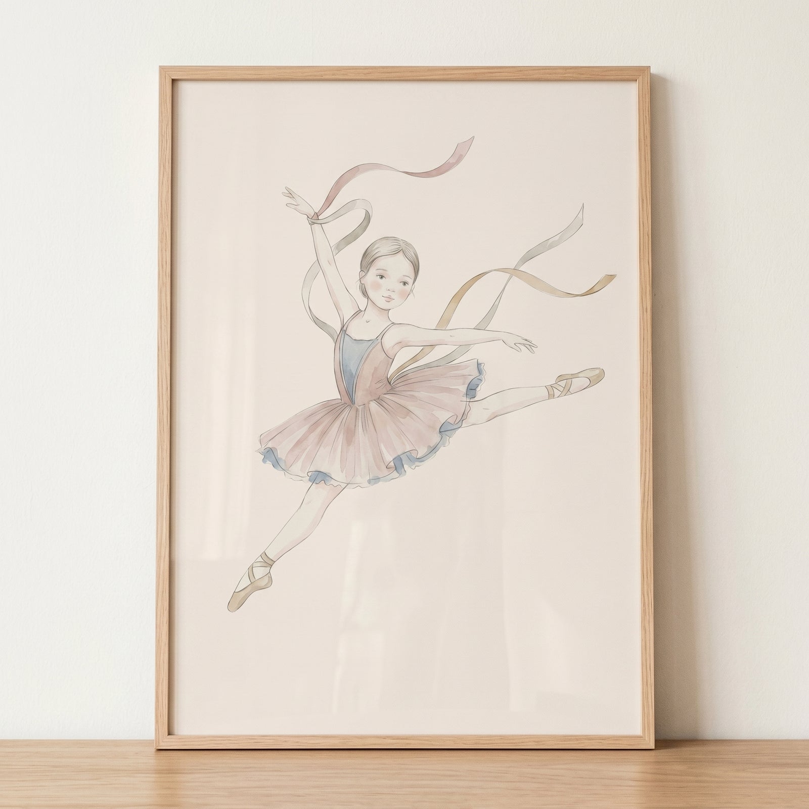 Flowing silk ribbon ballerina artwork of a leaping dancer in a pink tutu and pointe shoes, set in a light wood frame.